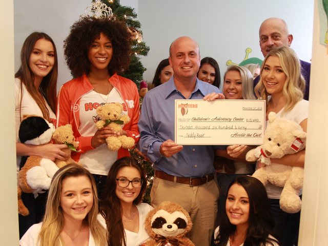Hooters Girls give Child Advocacy Center Check